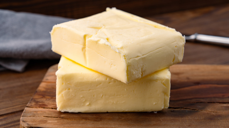 homemade butter blocks stacked on a cutting board