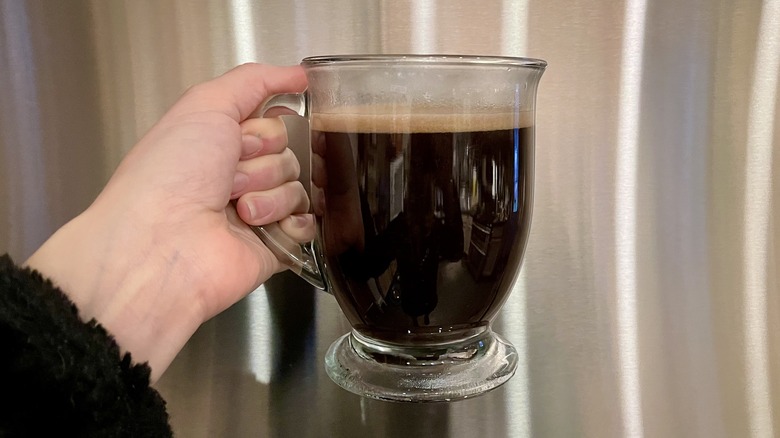 Hand holding cup of coffee