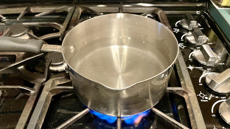 Lit stove heating water