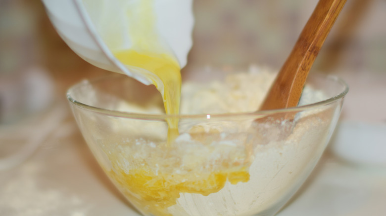adding melted butter to cookie mixture