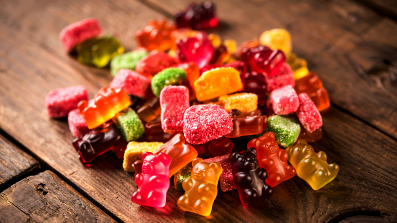 Multi-colored gummy bears on a wooden background