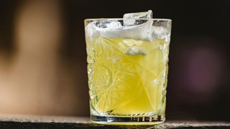 A whisky or Scotch sour in a rocks glass.