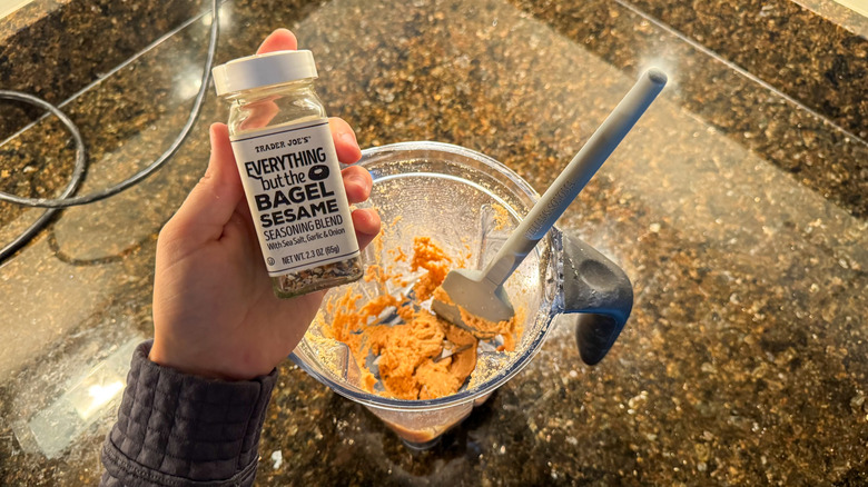 Everything bagel seasoning in hand with peanut butter