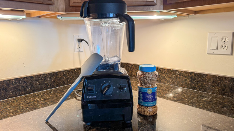 Vitamix blender with spatula and peanuts
