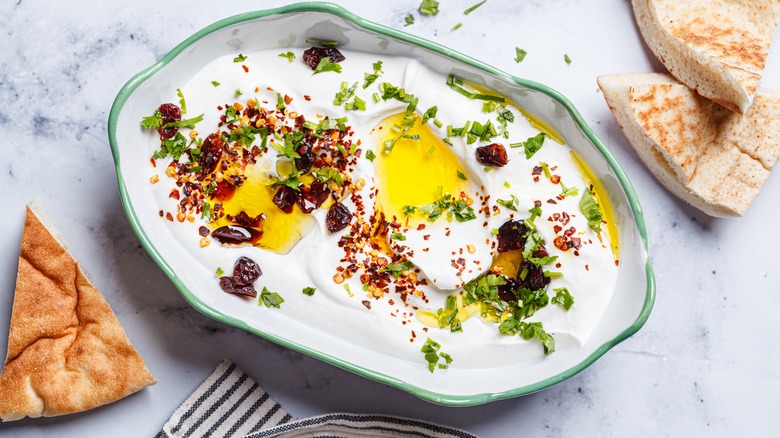 Whipped ricotta dip with chili, oil and cilantro.
