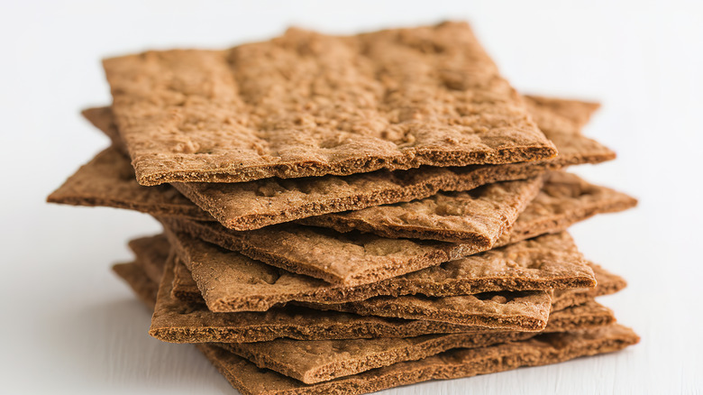 rye crackers stacked on white background