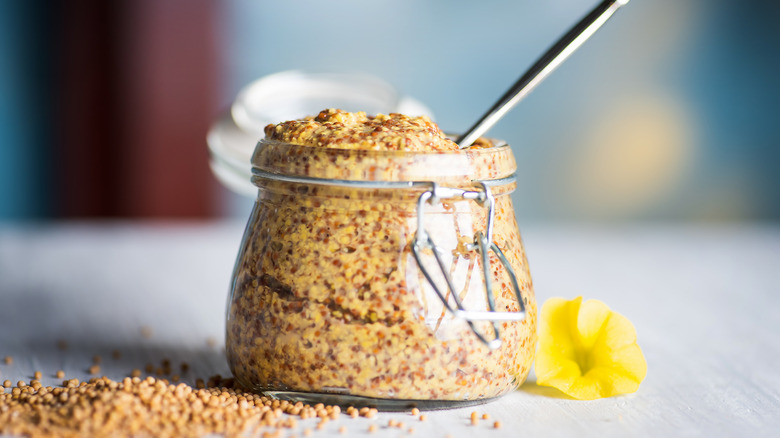 wholegrain mustard in glass jar on table