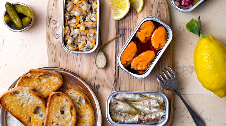 tinned mussels with fork and garnishes