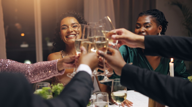friends toasting at a dinner party
