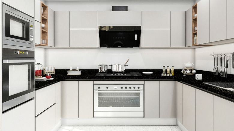 White C-shaped kitchen with integrated appliances