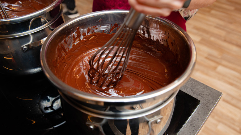 Chocolate being melted on a stovetop in a double boiler setup