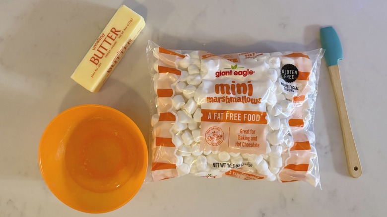 butter, water, mini marshmallows, and a spatula.