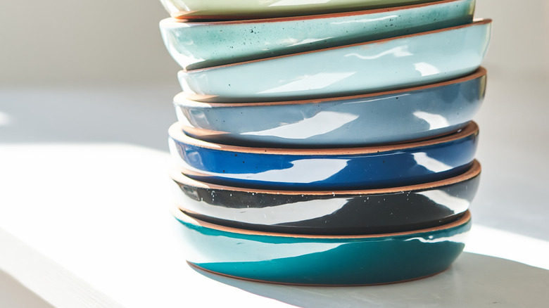 brightly colored stacked plates in different colors