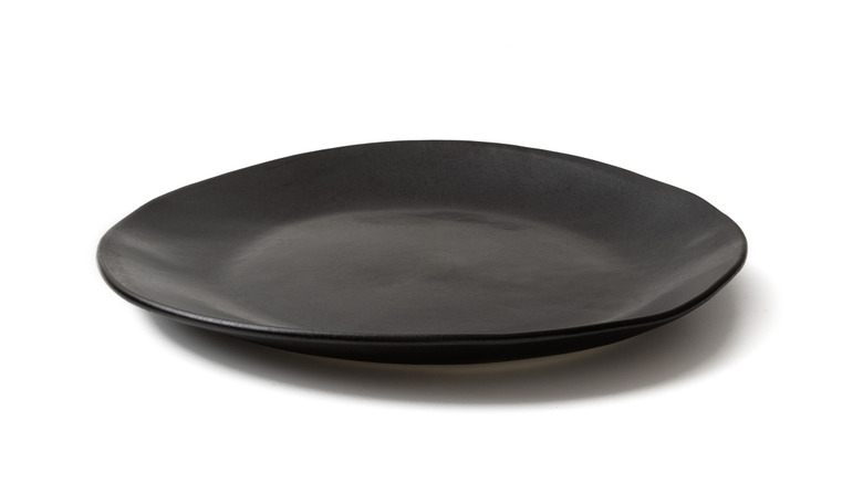 black stoneware plate on white background