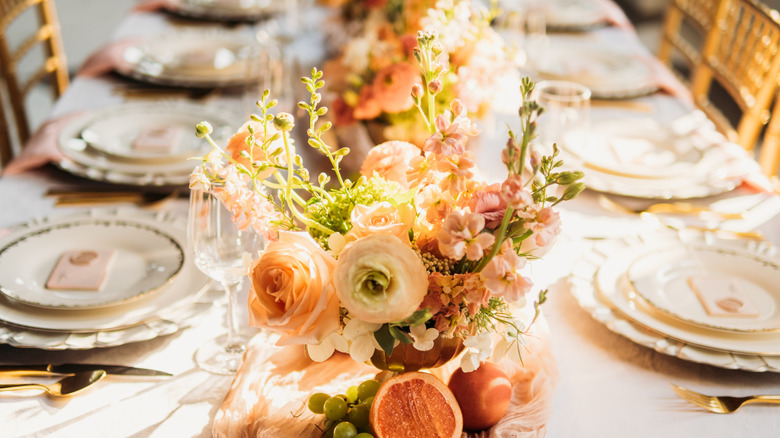 tablescape with stacked plates and flowers
