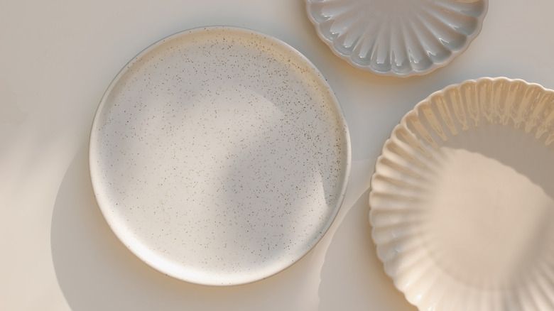 round and scalloped plates on mauve background