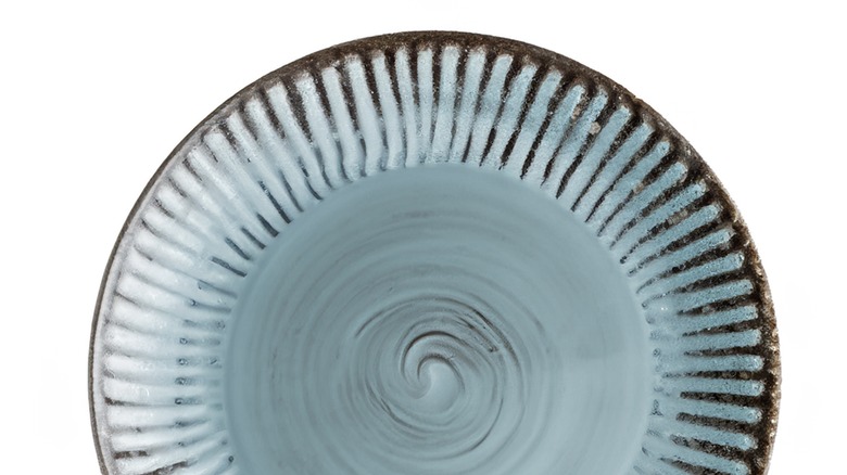 textured blue and brown ceramic plate on white background