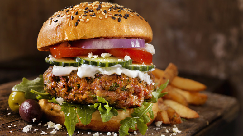 A Greek style lamb burger, with tomatoes, onions, cucumber and feta.