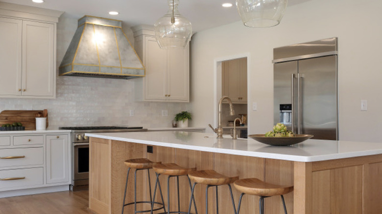 white colored kitchen cabinets in a light kitchen