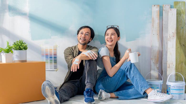 couple painting swatches on walls
