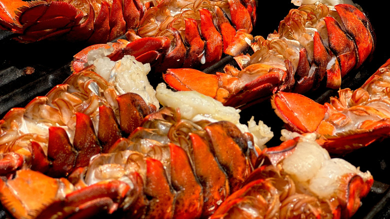 Lobster tails upside down on a grill