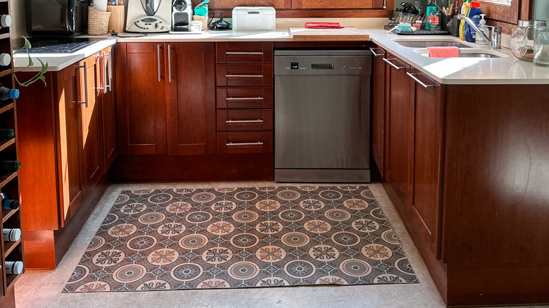 dark kitchen cabinets with geometric area rug
