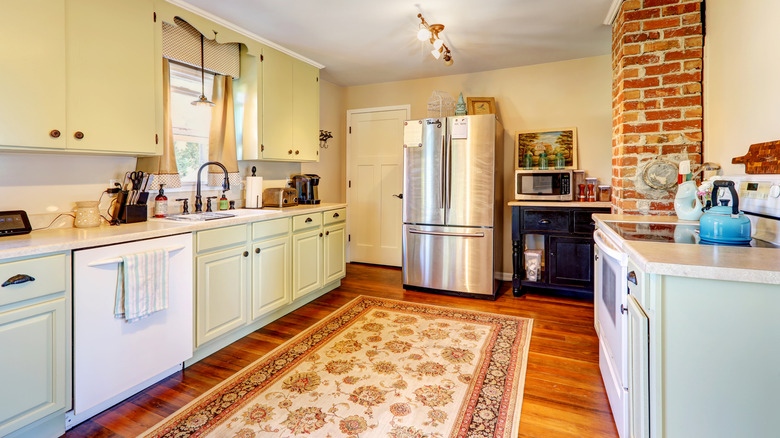 kitchen with brick detailing and coordinating area rug