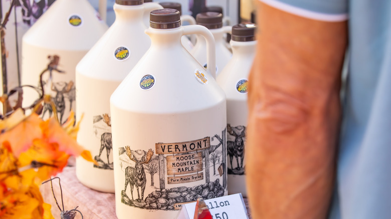 gallon jugs of maple syrup at market