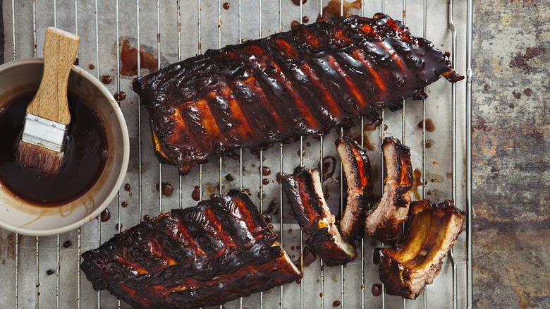 babyback ribs with barbecue sauce and a brush