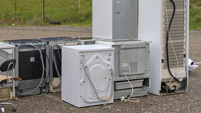 Secondhand appliances outside on pavement at a flea market