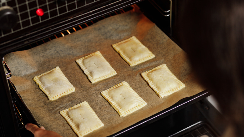 pop tarts in an oven on parchment paper on a sheet pan