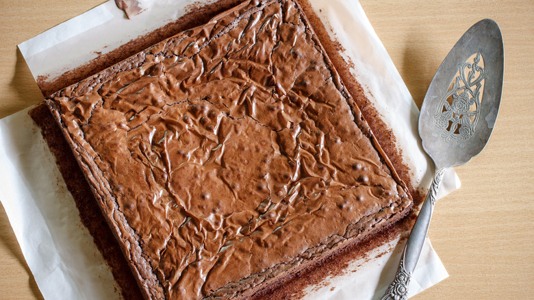 A batch of uncut brownies with crusty edges.