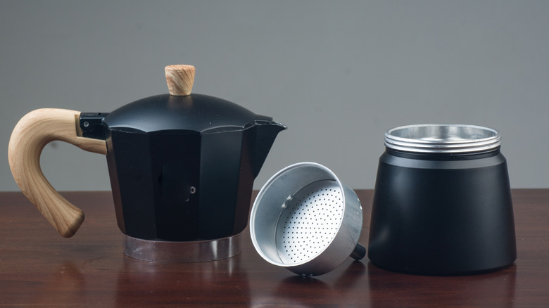 a disassembled black Moka pot