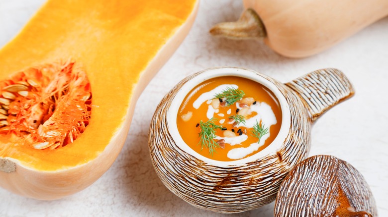 Half of a butternut squash and a bowl of soup