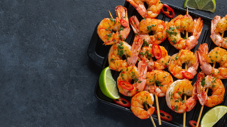grilled shrimp skewers in a black plate