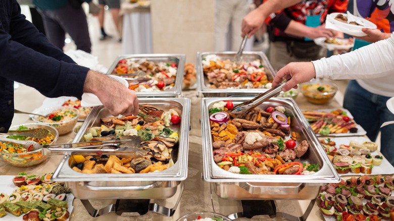 People gathered around buffet table