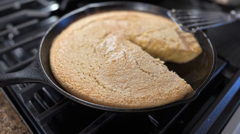 A cast iron pan of cornbread on the stovetop