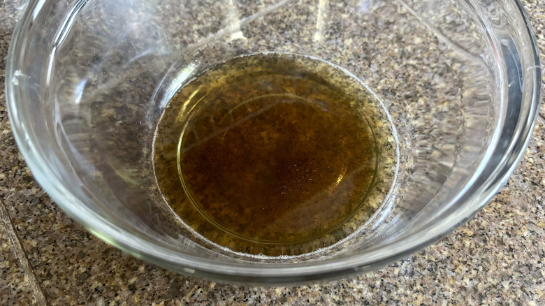 Strained bacon grease in the bottom of a glass bowl