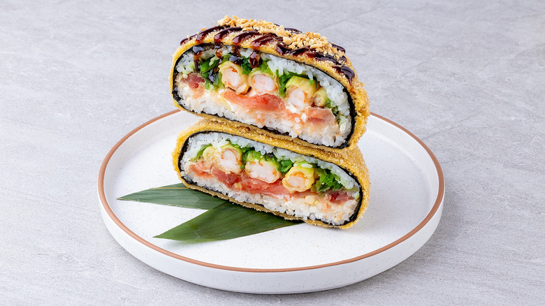 A sushi sandwich filled with shellfish and raw fish