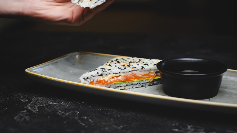 A sushi sandwich with salmon and avocado