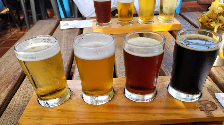 four beers in a flight from light to red to dark