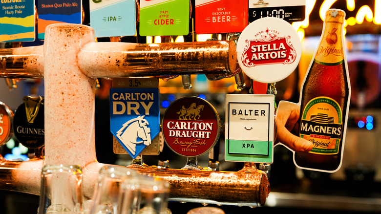 close up beer and cider taps at bar