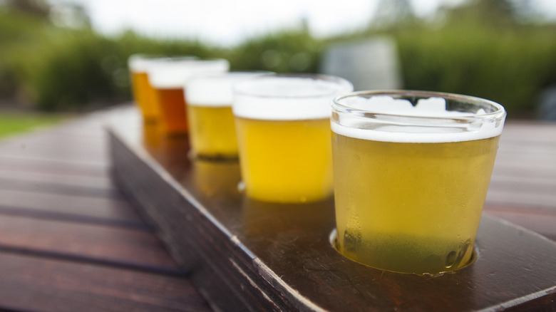 flight of small beers in wooden holder
