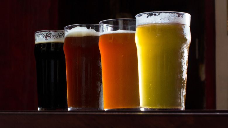 four pints of beer: dark, red, amber, and lager