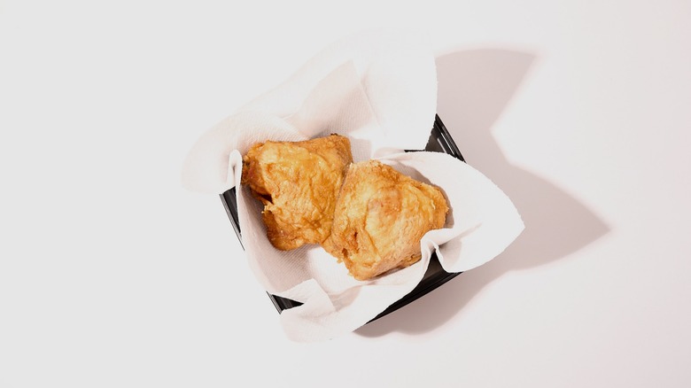 Fried chicken in a container with paper towel