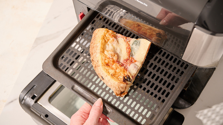 Adding frozen pizza to the air fryer