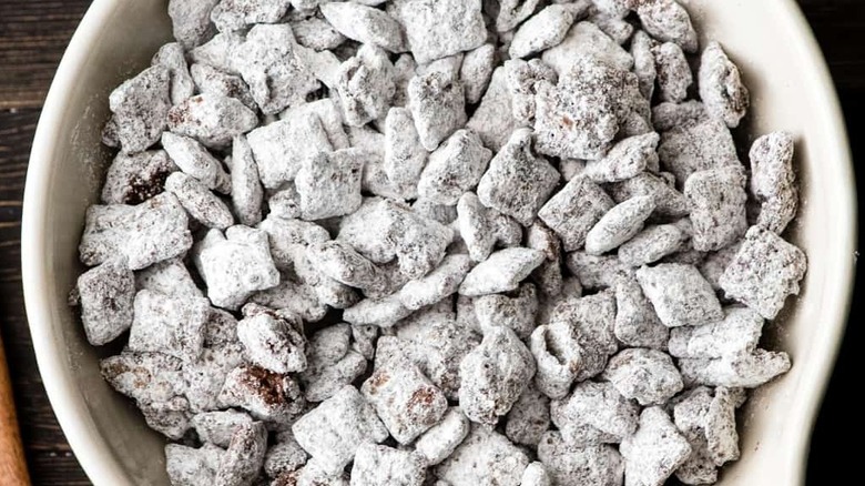 Bowl of puppy chow dessert on wooden table