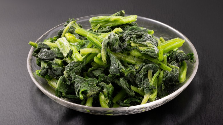 Frozen spinach thawing in a bowl