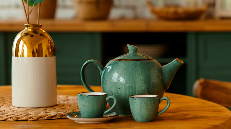 turquoise ceramic tea set on a wooden table