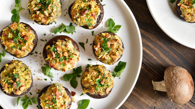 roasted stuffed mushroom caps on a white plate